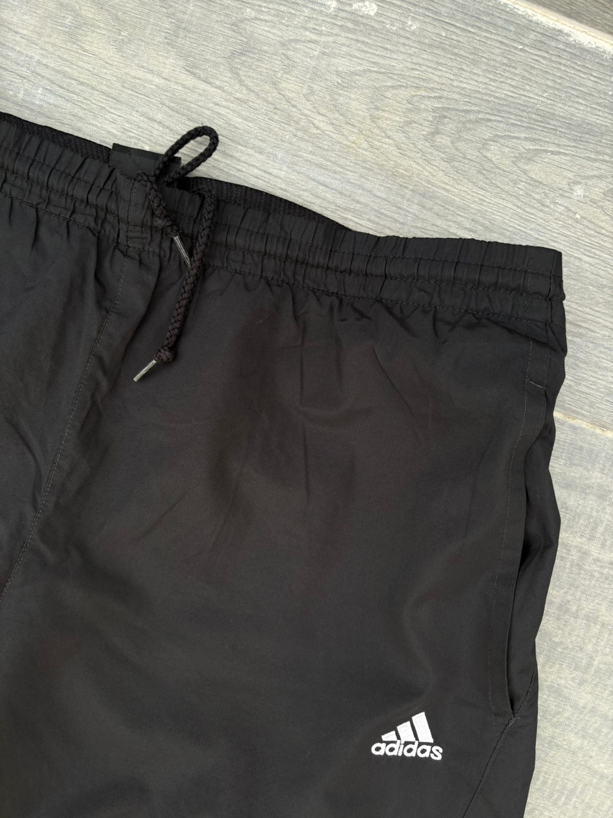 Black adidas and blue pants