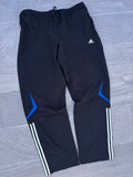 Black adidas and blue pants