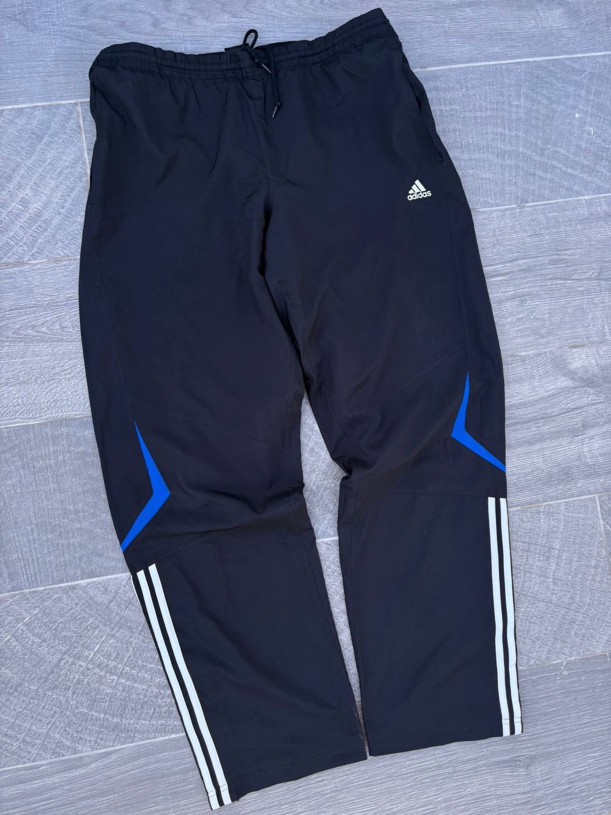Black adidas and blue pants