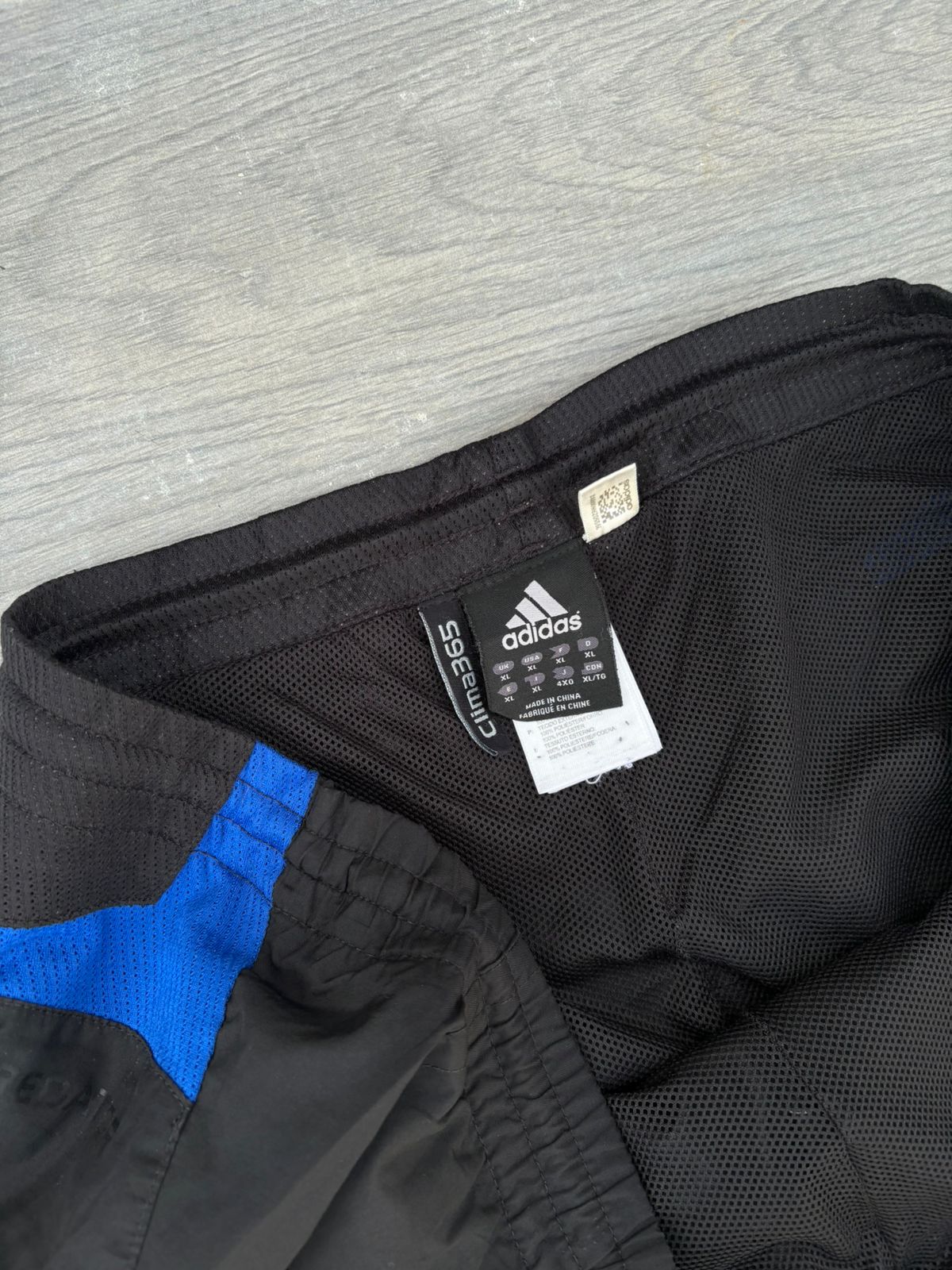 Black adidas and blue pants