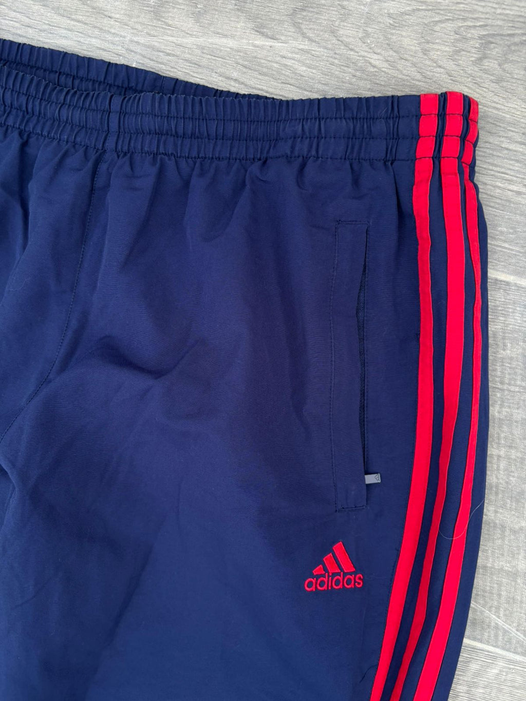Navy and red adidas pants